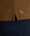 Model is wearing UNTUCKit Classic Cotton Long-Sleeve Polo in brown. 