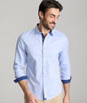 Model is wearing UNTUCKit wainwright shirt in blue.  
