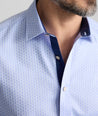 Model is wearing UNTUCKit wainwright shirt in blue.