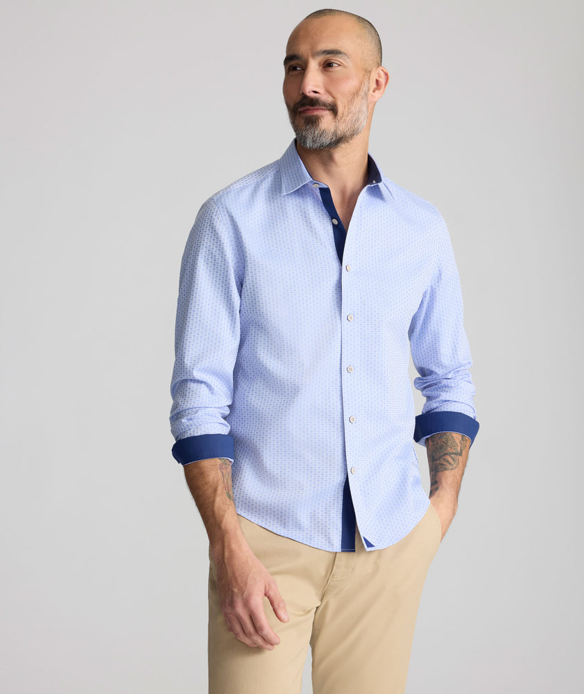 Model is wearing UNTUCKit wainwright shirt in blue.