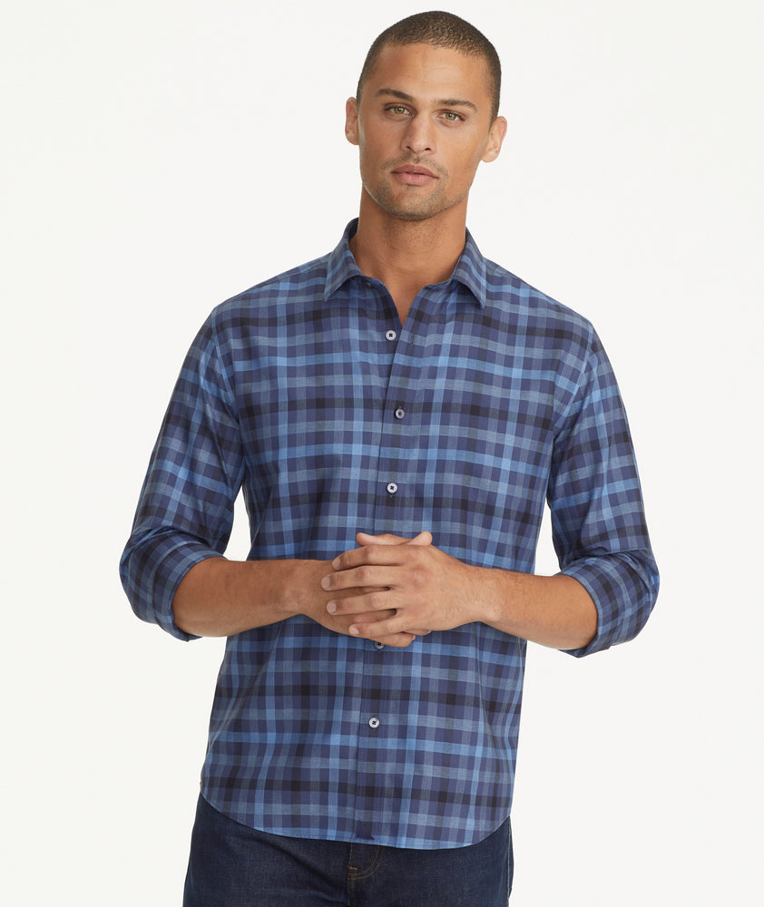 Model is wearing UNTUCKit Wrinkle-Free Walton Shirt in Blue & Black Check.