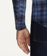 Model is wearing UNTUCKit Wrinkle-Free Walton Shirt in Blue & Black Check.