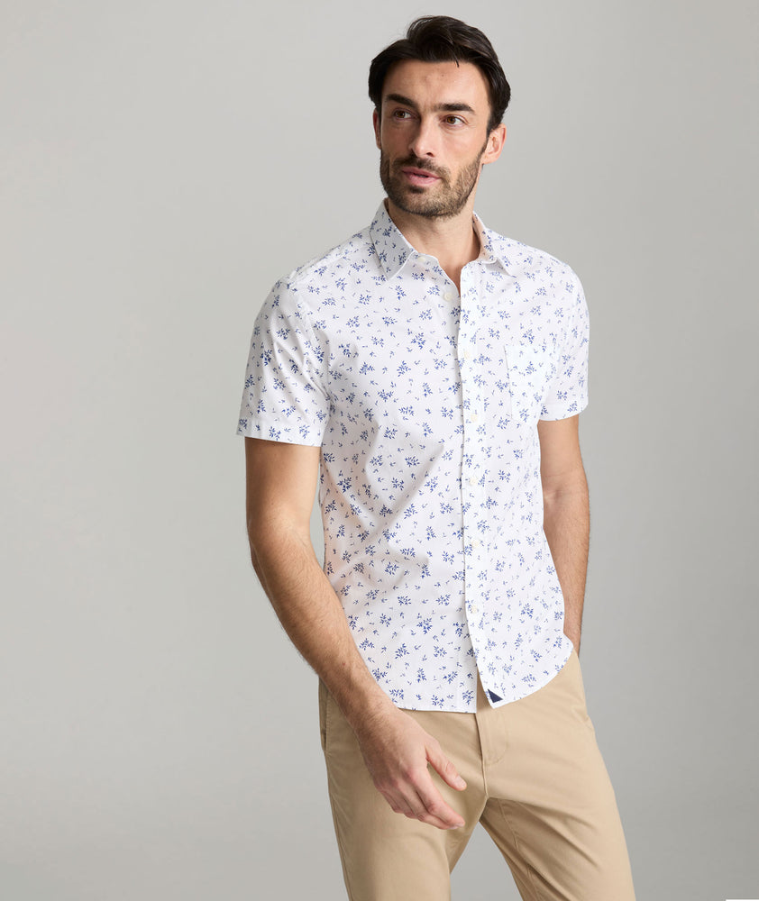 Model is wearing UNTUCKit ward short sleeve shirt in white floral print. 