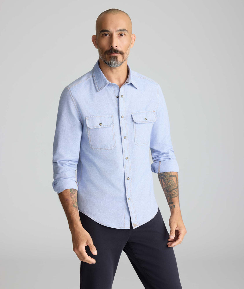 Model is wearing UNTUCKit Vintage Wash Western Shirt in blue. 