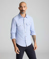 Model is wearing UNTUCKit Vintage Wash Western Shirt in blue. 