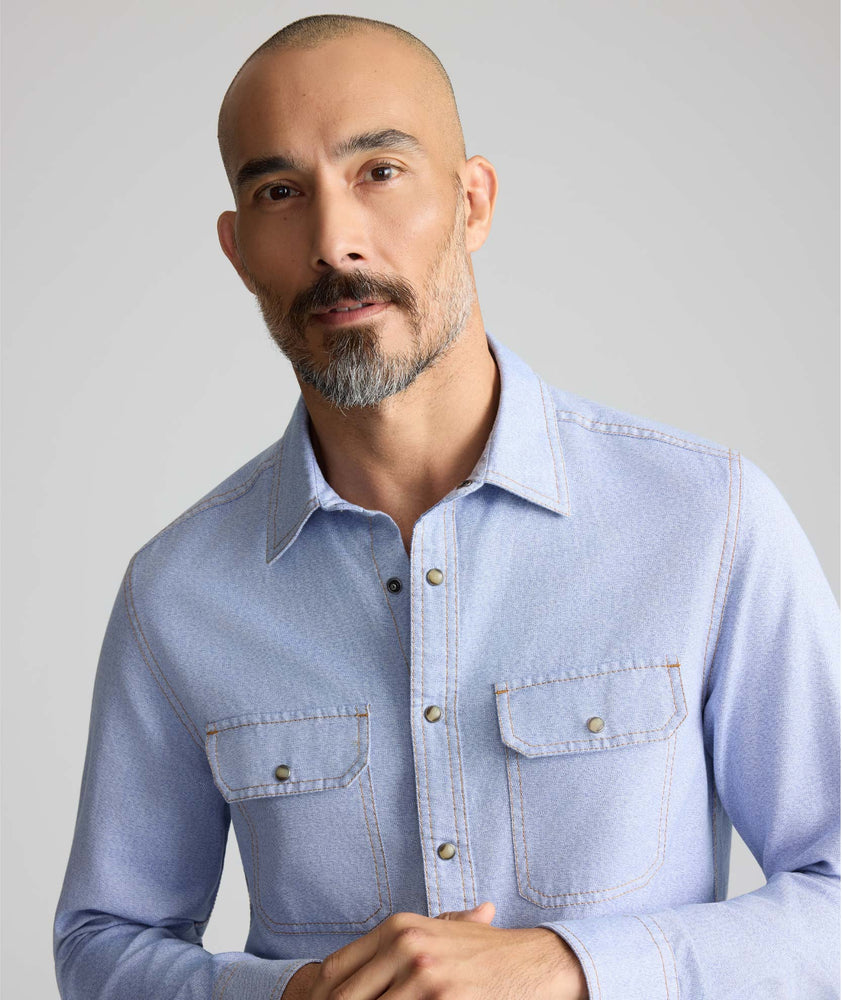 Model is wearing UNTUCKit Vintage Wash Western Shirt in blue. 