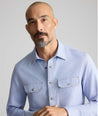 Model is wearing UNTUCKit Vintage Wash Western Shirt in blue. 