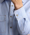 Model is wearing UNTUCKit Vintage Wash Western Shirt in blue. 