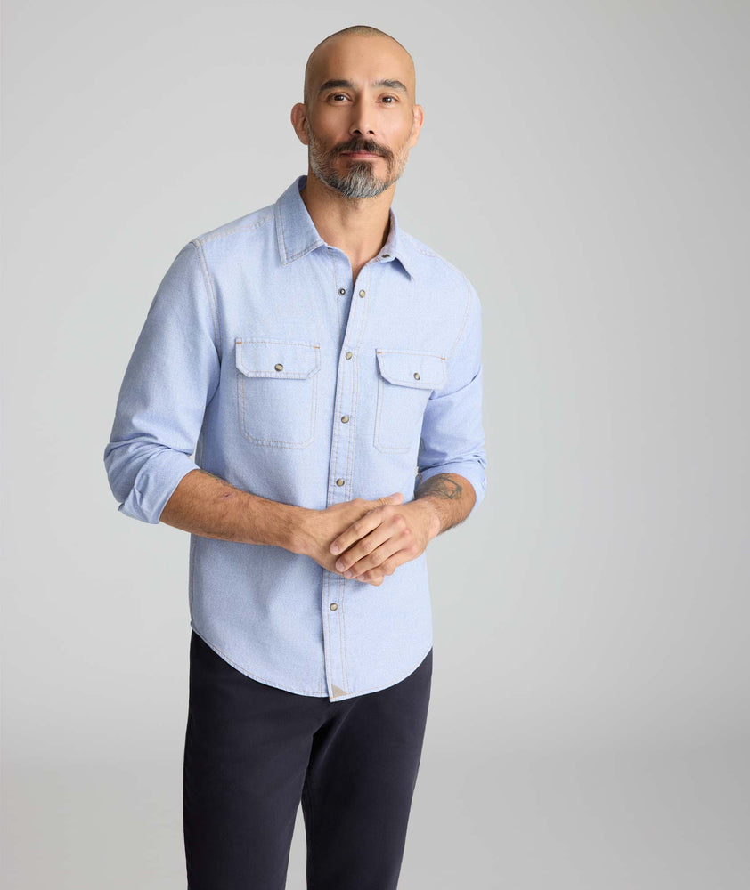 Model is wearing UNTUCKit Vintage Wash Western Shirt in blue. 