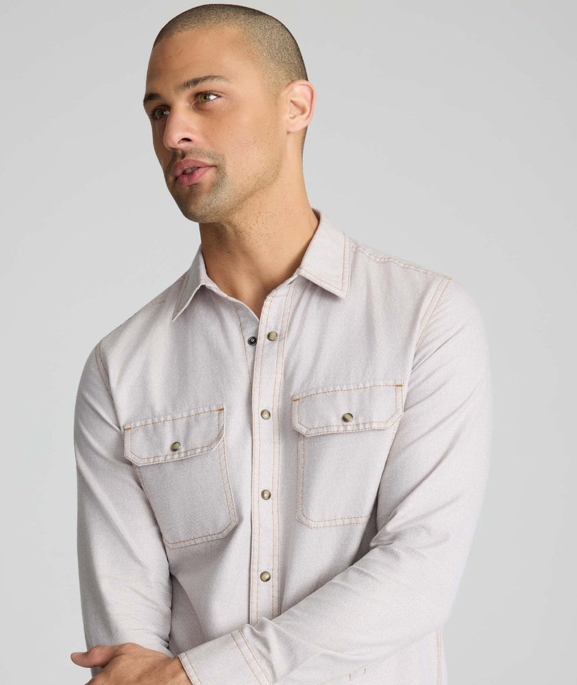 Model is wearing UNTUCKit Vintage Wash Western Shirt in tan.