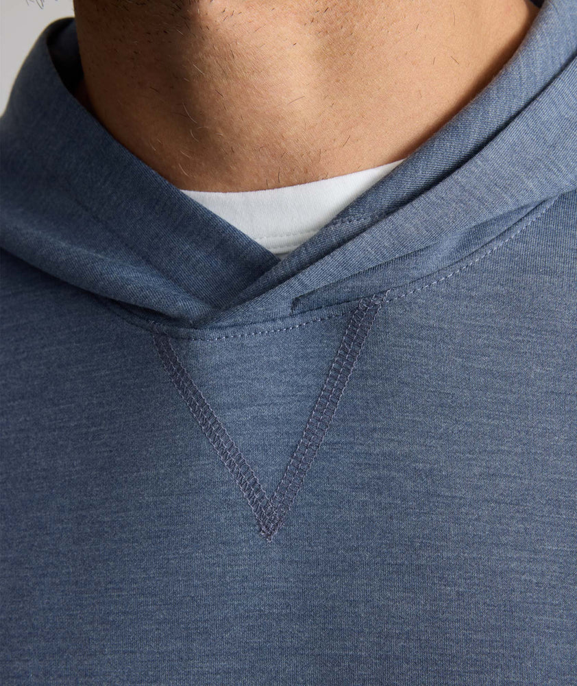 Model is wearing UNTUCKit watherby perfroamnce hoodie in blue. 