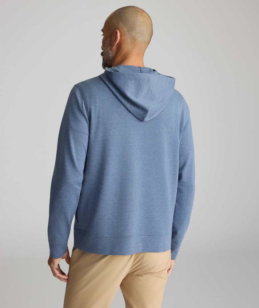 Model is wearing UNTUCKit watherby perfroamnce hoodie in blue. 