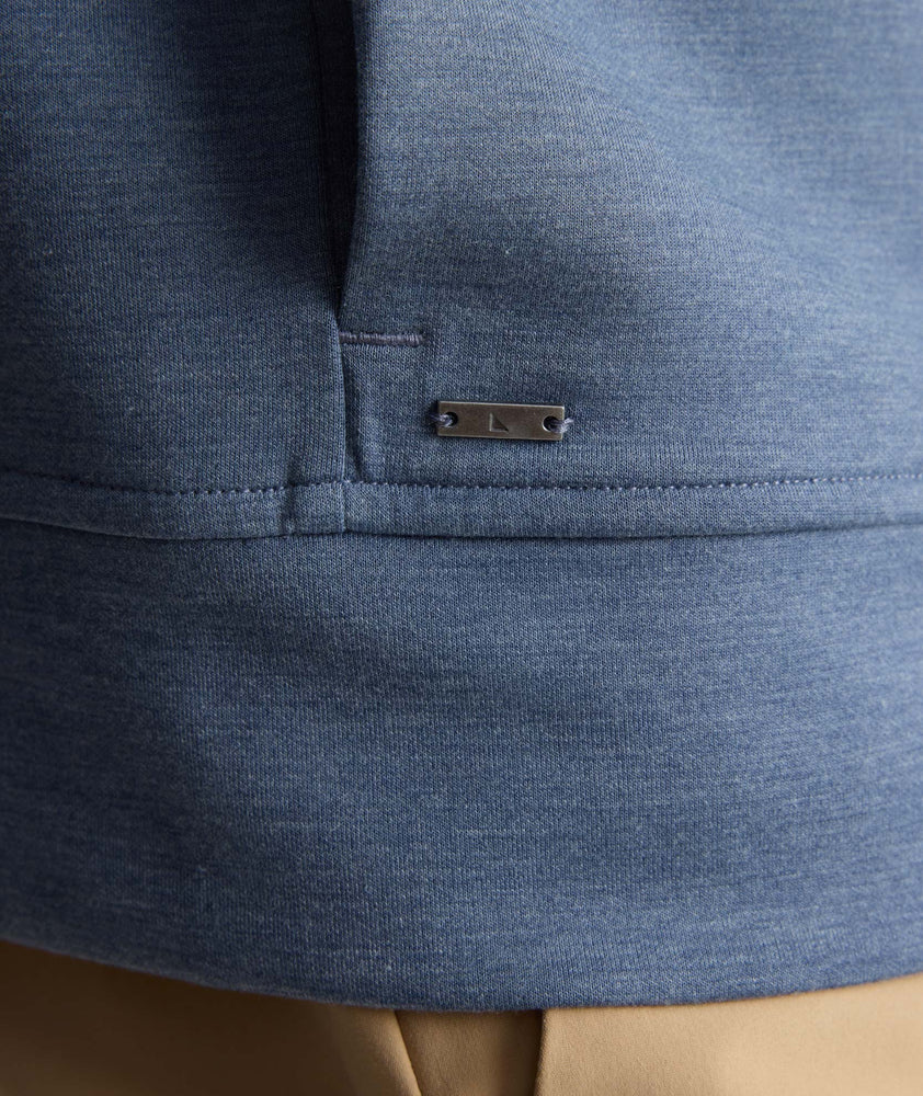 Model is wearing UNTUCKit watherby perfroamnce hoodie in blue. 