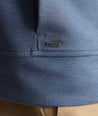 Model is wearing UNTUCKit watherby perfroamnce hoodie in blue. 