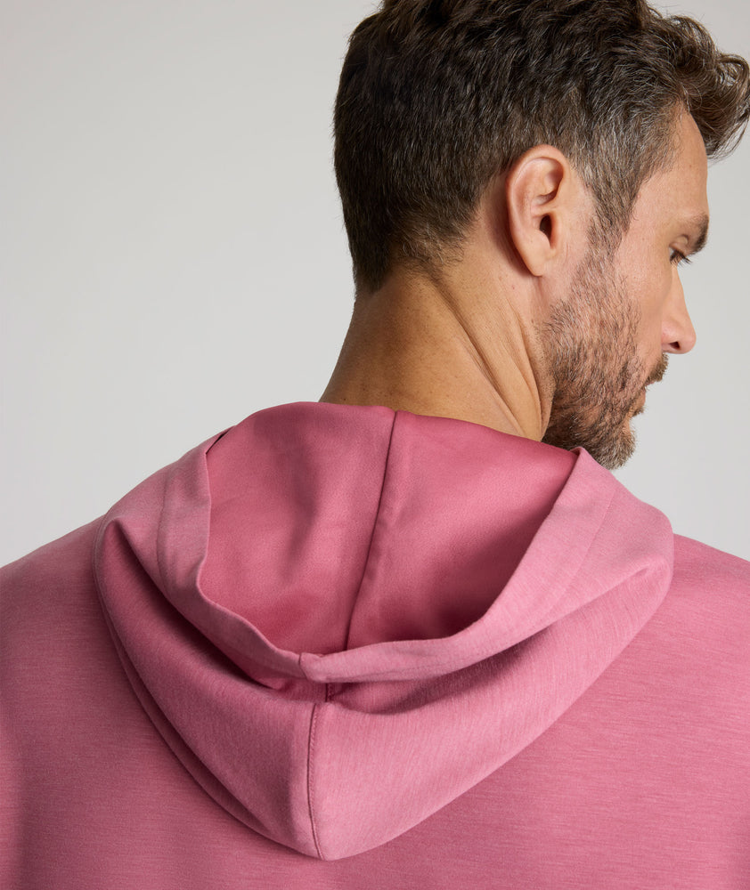Model is wearing UNTUCKit Weatherby Performance Hoodie in Rose Wine.