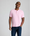 Model is wearing UNTUCKit westray henley in stripe pink. 