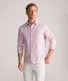 Model is wearing UNTUCKit Performance Whitman Shirt in Pink & Blue Plaid.