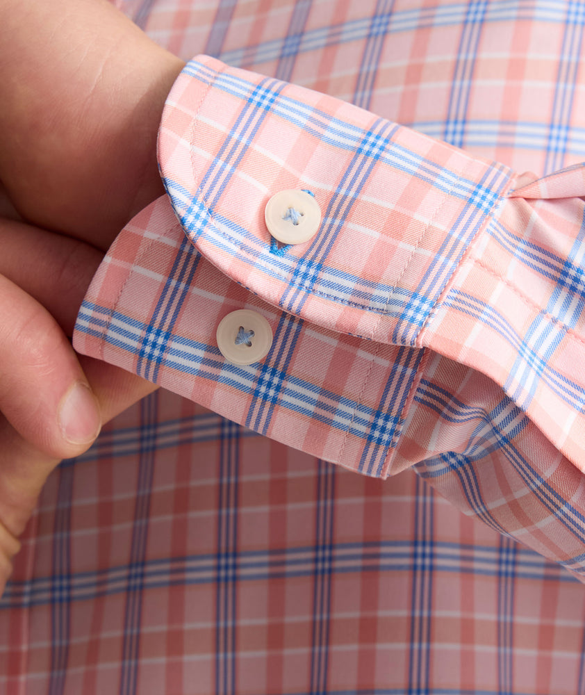 Model is wearing UNTUCKit Performance Whitman Shirt in Pink & Blue Plaid.