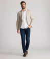 Model is wearing UNTUCKit Whittle tan sport coat. 