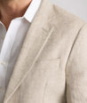 Model is wearing UNTUCKit Whittle tan sport coat. 