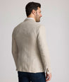 Model is wearing UNTUCKit Whittle tan sport coat. 