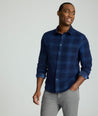 Model is wearing Cord Shirt in Navy Plaid.