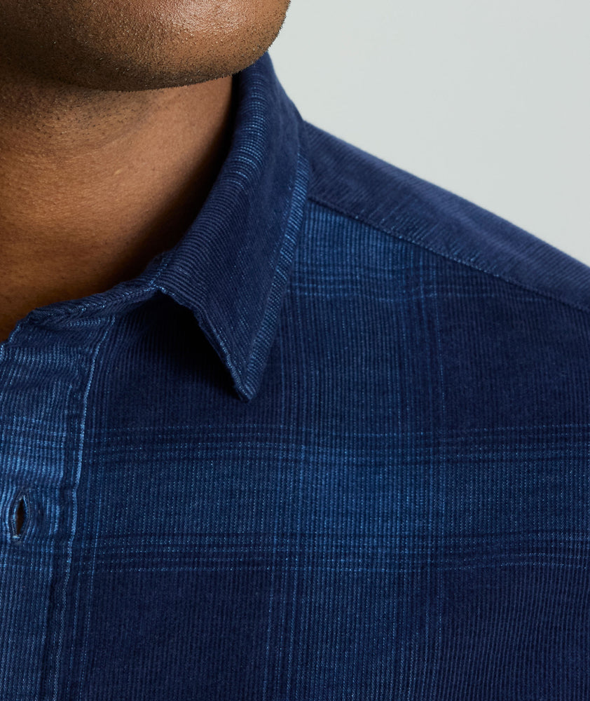Model is wearing Cord Shirt in Navy Plaid.