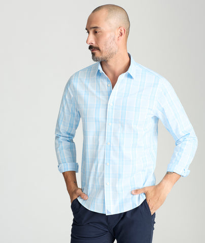 Model is wearing UNTUCKit yates wrinkle-free shirt in light blue large plaid. 