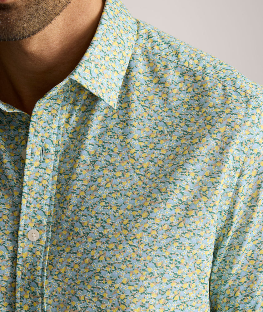 Model is wearing UNTUCKit Yorke performance short sleeve green and yellow floral print shirt. 