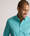 Model is wearing UNTUCKit Yorksley performance shirt in in teal tiny gingham. 