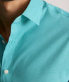 Model is wearing UNTUCKit Yorksley performance shirt in in teal tiny gingham. 