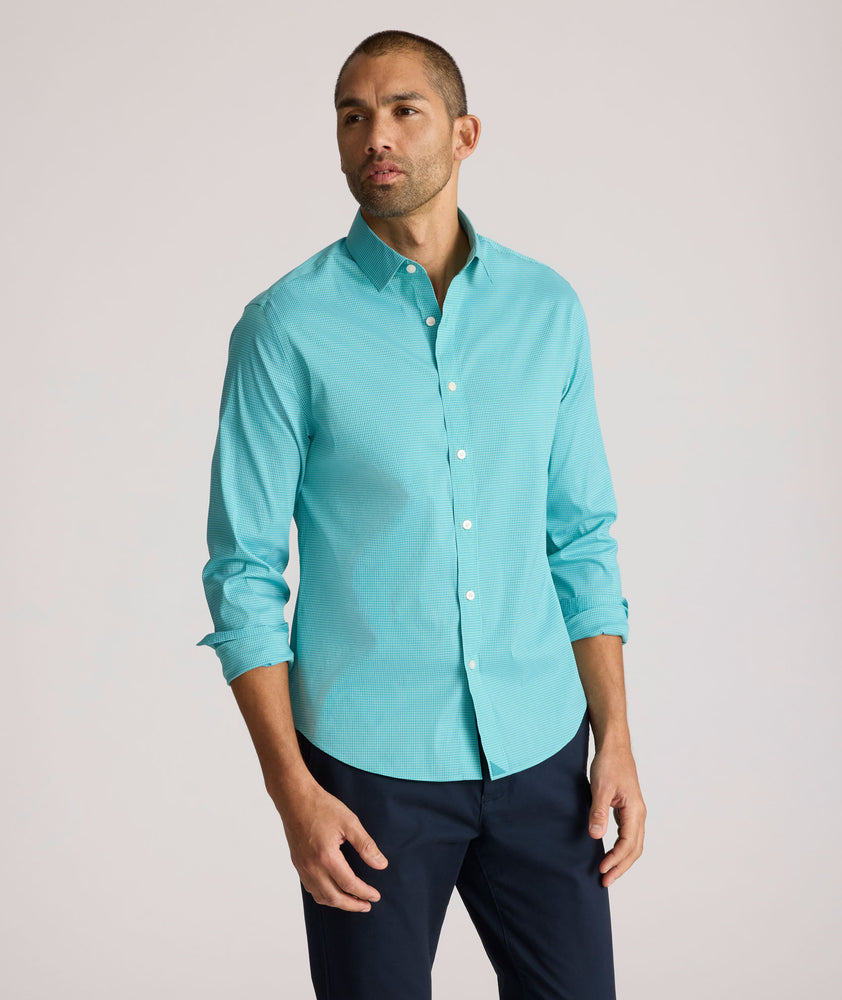 Model is wearing UNTUCKit Yorksley performance shirt in in teal tiny gingham. 