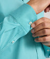 Model is wearing UNTUCKit Yorksley performance shirt in in teal tiny gingham. 