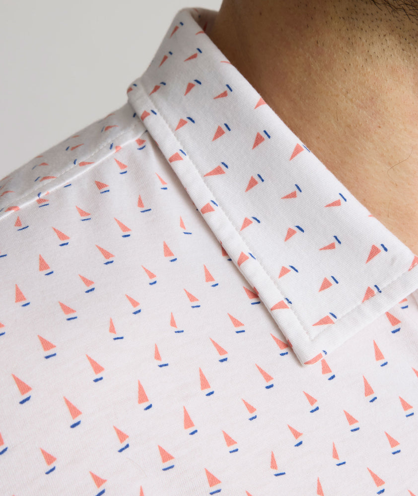 Model is wearing UNTUCKit Zandt Printed Performance Polo in White Coral.