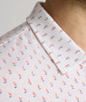 Model is wearing UNTUCKit Zandt Printed Performance Polo in White Coral.