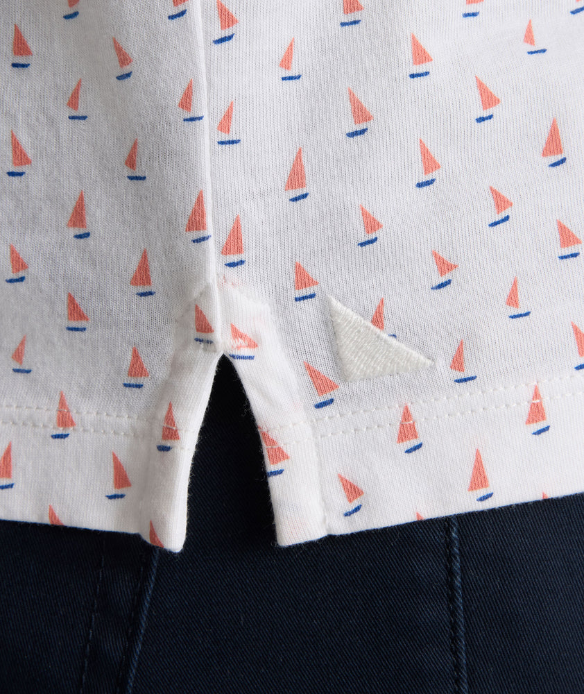 Model is wearing UNTUCKit Zandt Printed Performance Polo in White Coral.