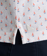 Model is wearing UNTUCKit Zandt Printed Performance Polo in White Coral.