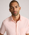 Model is wearing UNTUCKit zeller performance short sleeve shirt in pink geo. 