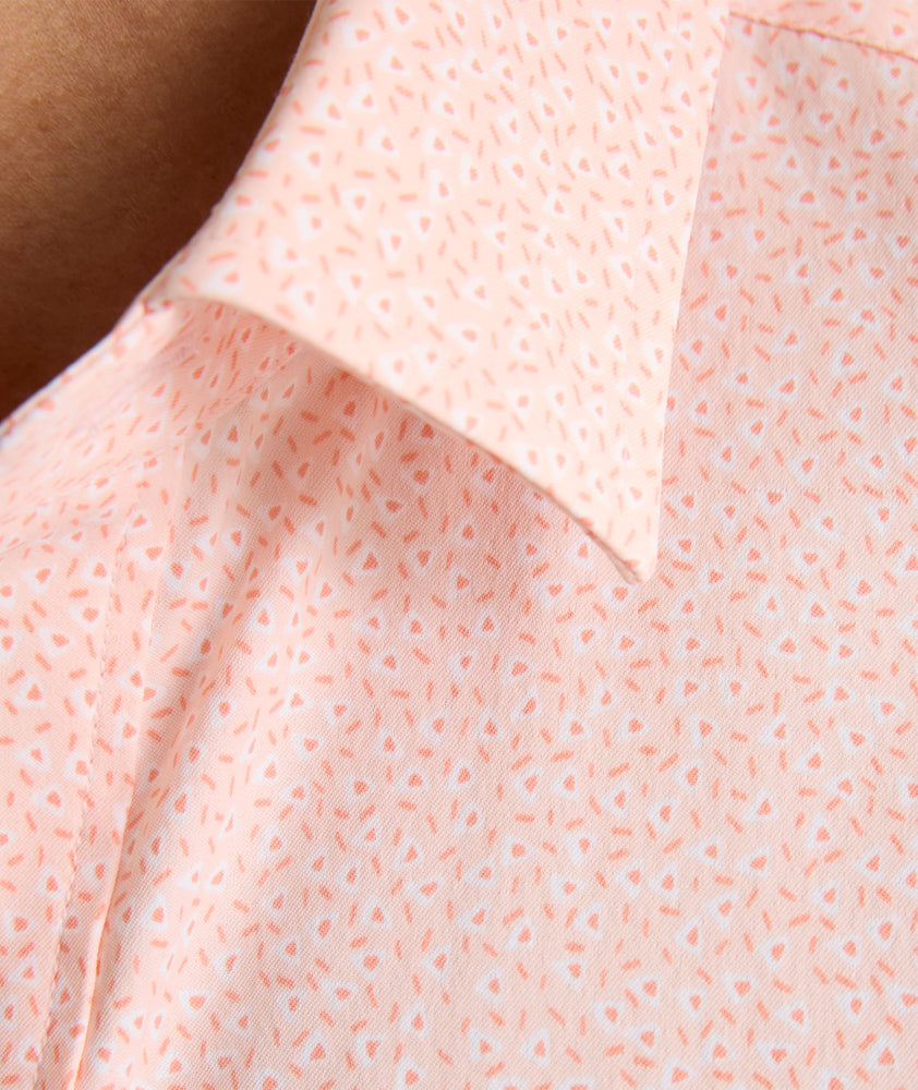 Model is wearing UNTUCKit zeller performance short sleeve shirt in pink geo. 