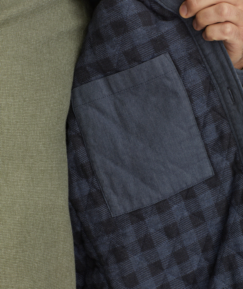 Model is wearing UNTUCKit Ziraldo Jacket in navy. 