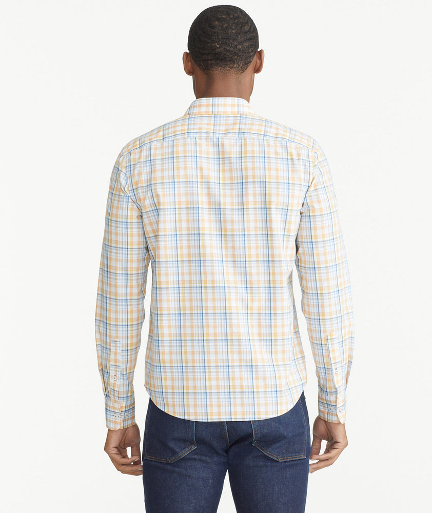 Model is wearing UNTUCKit Orange Plaid Wrinkle-Free Abrusco Shirt.