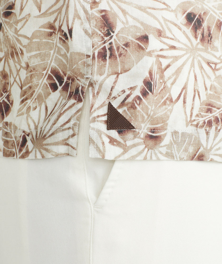 Model is wearing an UNTUCKit Tan Leaf Print Linen Short-Sleeve Aidani Shirt