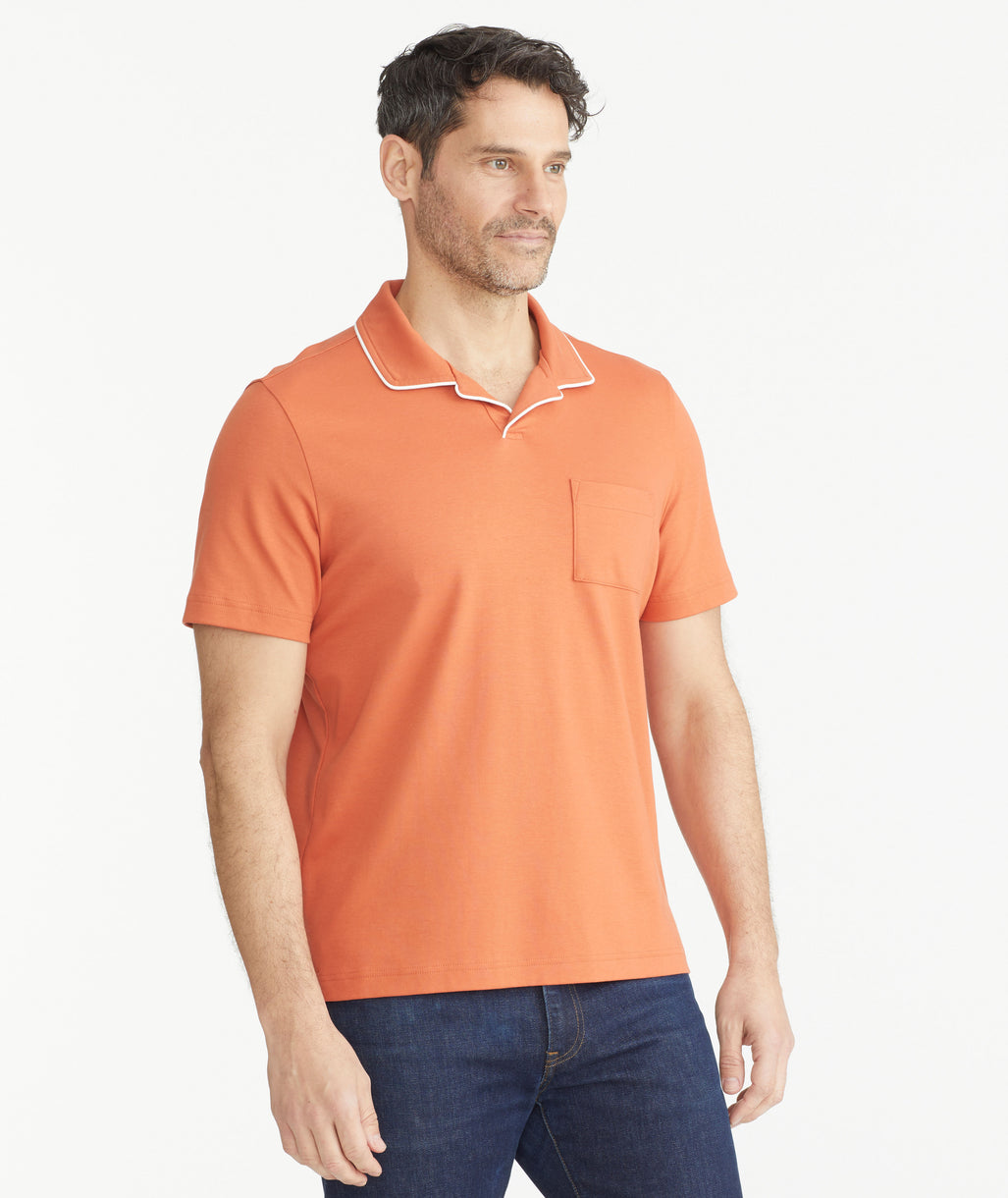 Model is wearing UNTUCKit orange Tipped Johnny Collar Polo.