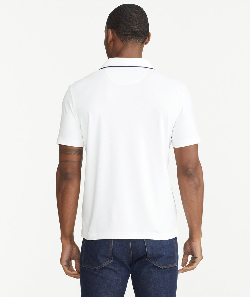 Model is wearing UNTUCKit White Tipped Johnny Collar Polo.