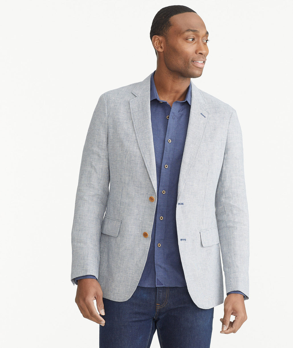 Model is wearing UNTUCKit Blue Houndstooth Italian Linen Atticus Sport Coat.
