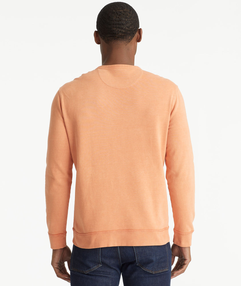 Model wearing an UNTUCKit Orange Mineral Dye Sweatshirt