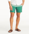 Model wearing UNTUCKit Green 7-Inch Recycled Swim Trunks