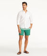 Model wearing UNTUCKit Green 7-Inch Recycled Swim Trunks