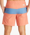 Model wearing UNTUCKit Orange 7-Inch Recycled Swim Trunks