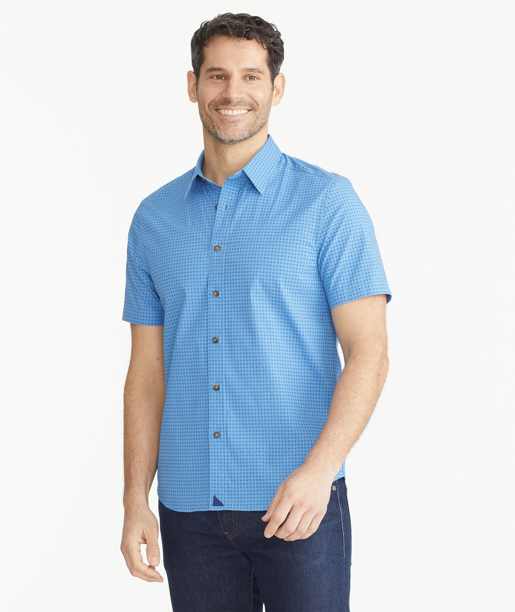 Model is wearing UNTUCKit Blue Geo Cotton Printed Short- Sleeve Shirt.
